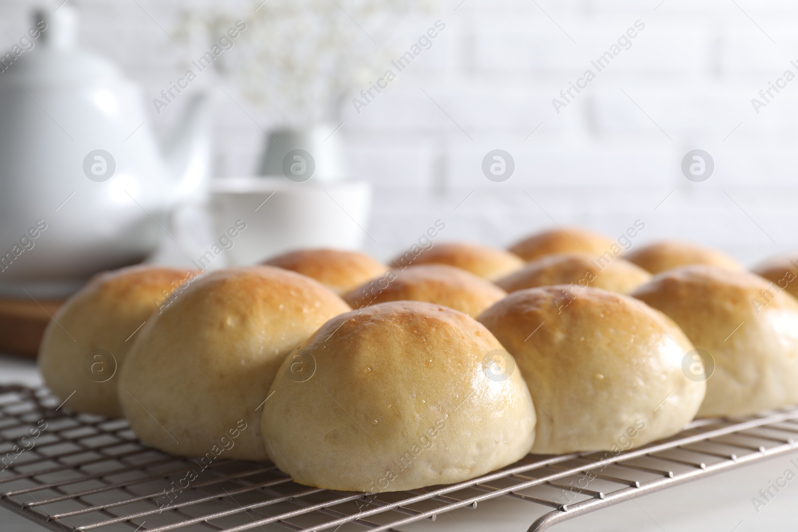 Photo of Delicious dough balls on white table, closeup