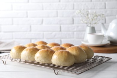 Photo of Delicious dough balls on white wooden table