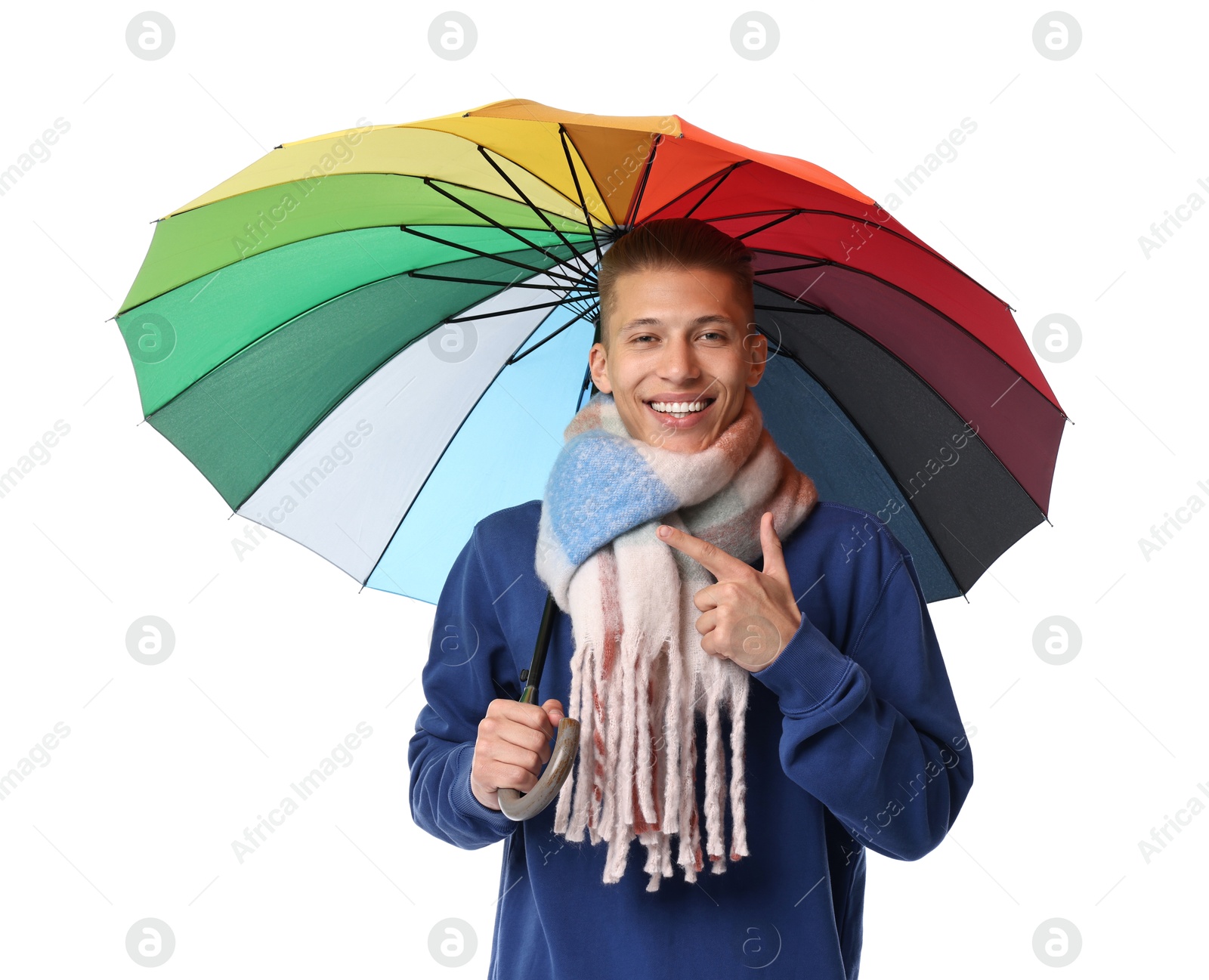 Photo of Young man with rainbow umbrella pointing on white background