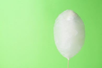 One sweet cotton candy on light green background. Space for text