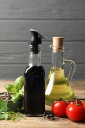 Bottle of balsamic vinegar, oil and other products on wooden table