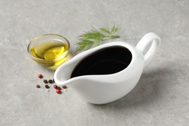 Balsamic vinegar, oil, peppercorns and dill on light grey table