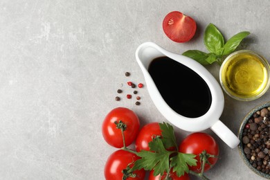 Balsamic vinegar, oil and other products on light grey table, flat lay. Space for text