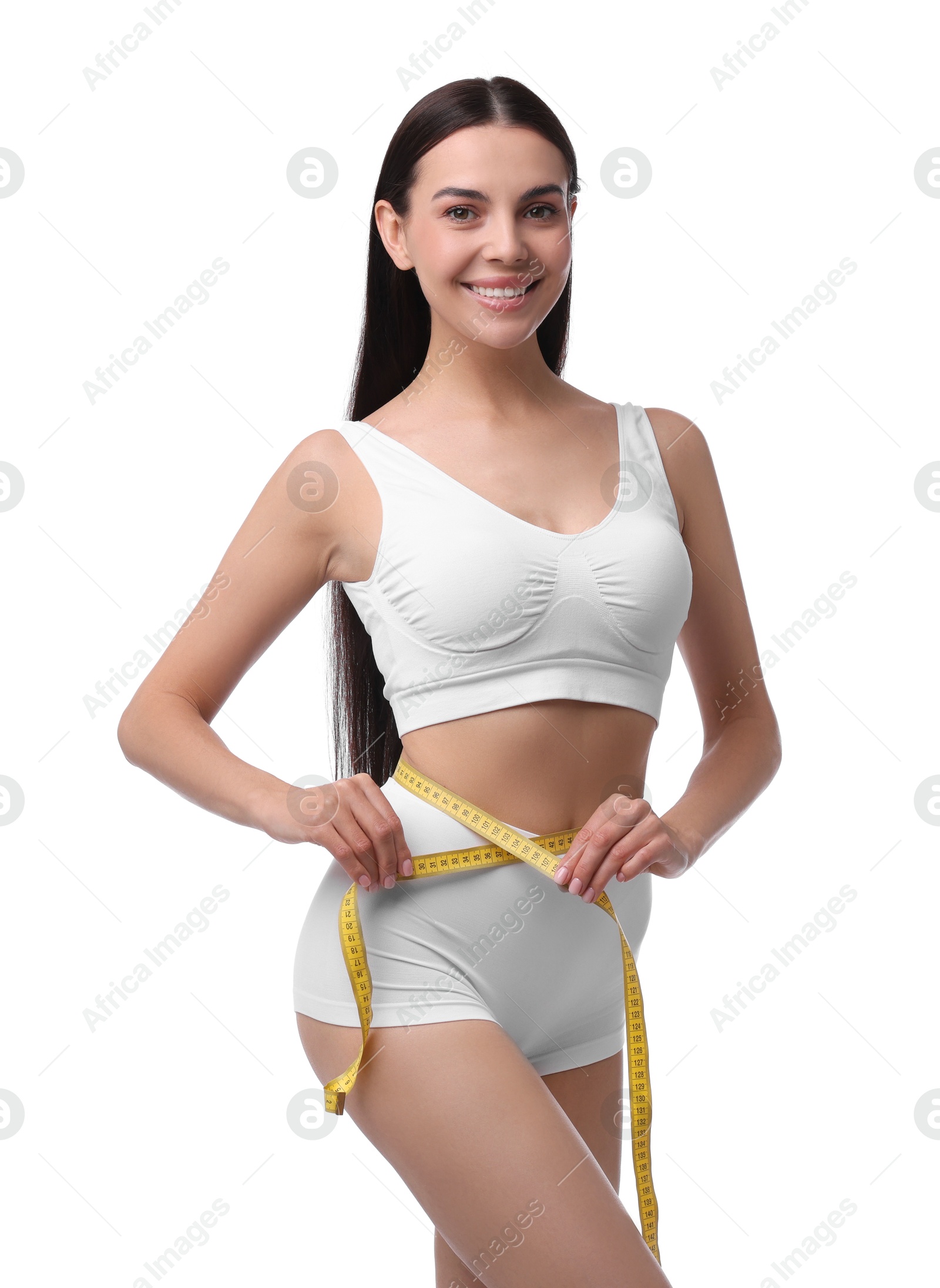 Photo of Diet and weight loss concept. Beautiful young woman with measuring tape showing her slim body against white background