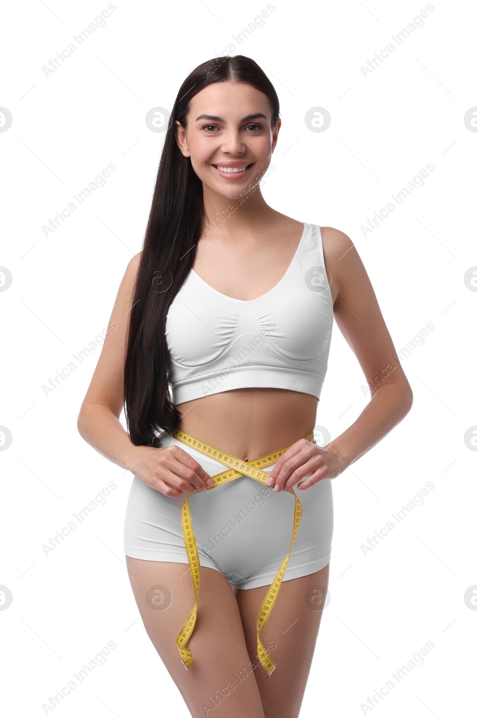 Photo of Diet and weight loss concept. Beautiful young woman with measuring tape showing her slim body against white background