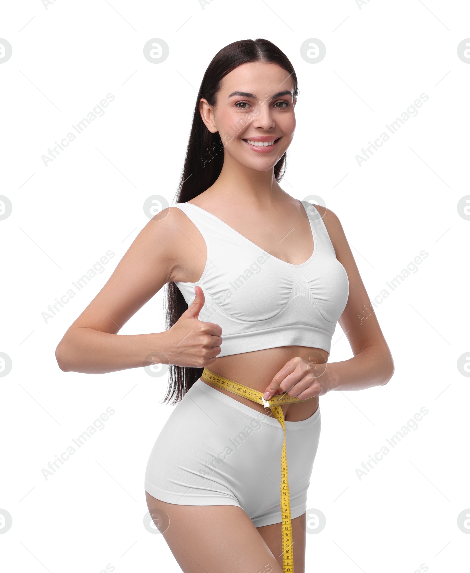 Photo of Diet and weight loss concept. Beautiful young woman with measuring tape showing her slim body against white background