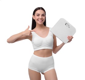 Diet and weight loss concept. Happy young woman with floor scale on white background