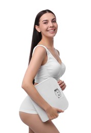 Photo of Diet and weight loss concept. Happy young woman with floor scale on white background