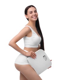 Photo of Diet and weight loss concept. Happy young woman with floor scale on white background