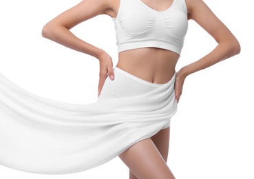 Photo of Diet and weight loss concept. Woman covering her slim body with silk fabric against white background, closeup