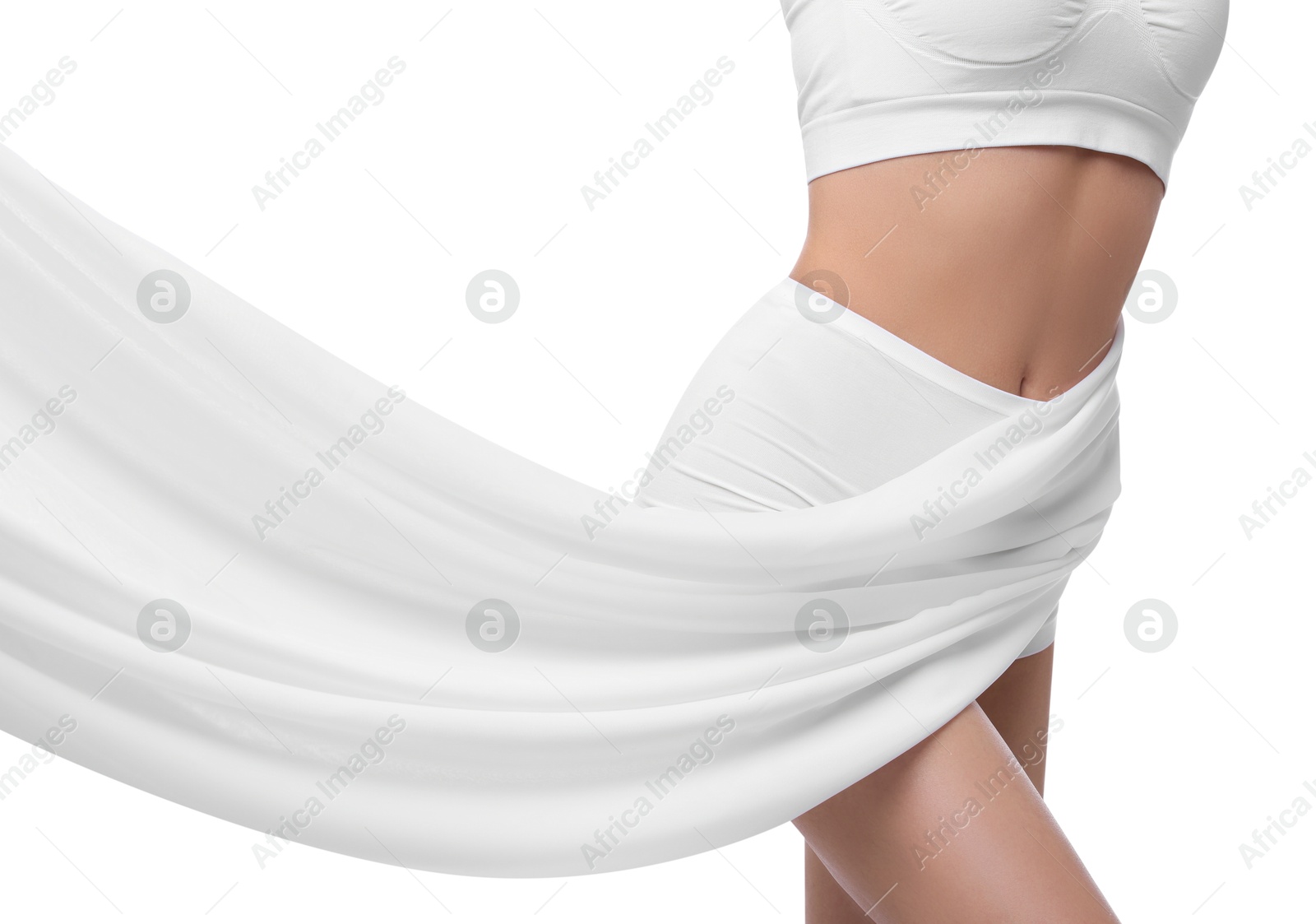 Photo of Diet and weight loss concept. Woman covering her slim body with silk fabric against white background, closeup