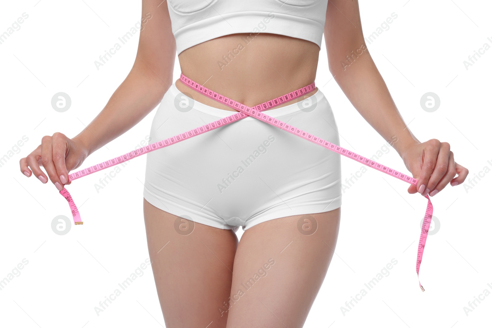 Photo of Diet and weight loss concept. Woman with measuring tape showing her slim body against white background, closeup