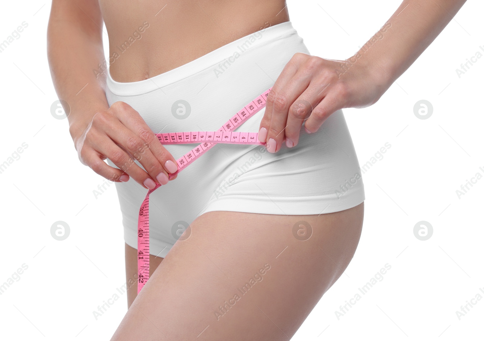 Photo of Diet and weight loss concept. Woman with measuring tape showing her slim body against white background, closeup