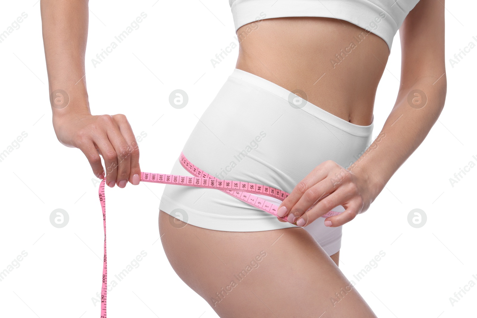 Photo of Diet and weight loss concept. Woman with measuring tape showing her slim body against white background, closeup