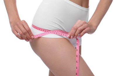 Photo of Diet and weight loss concept. Woman with measuring tape showing her slim body against white background, closeup