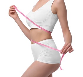 Photo of Diet and weight loss concept. Woman with measuring tape showing her slim body against white background, closeup