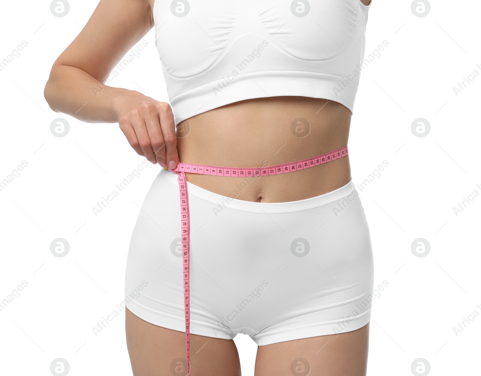 Photo of Diet and weight loss concept. Woman with measuring tape showing her slim body against white background, closeup