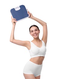 Photo of Diet and weight loss concept. Happy young woman with floor scale on white background