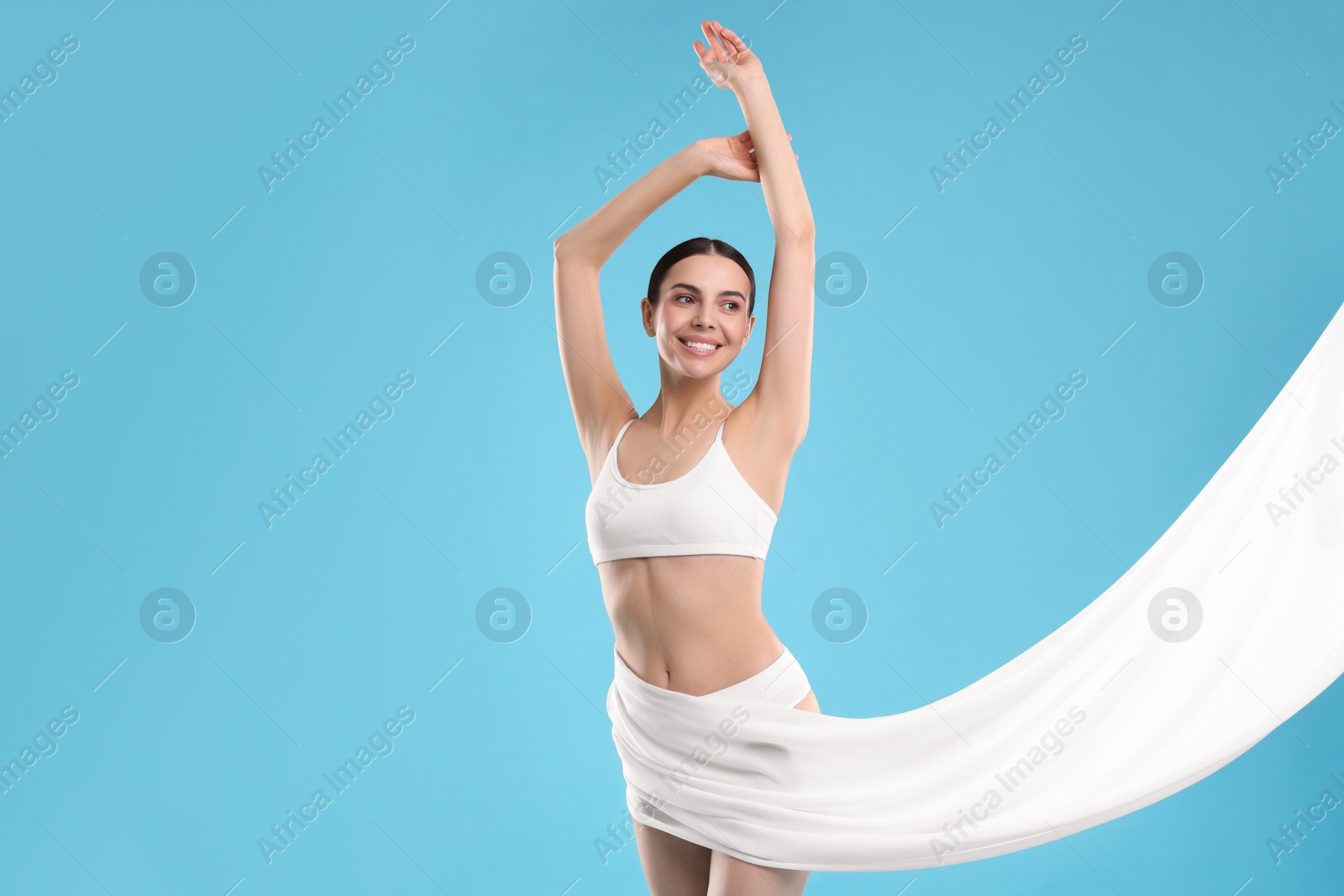 Photo of Diet and weight loss concept. Beautiful young woman with slim body on light blue background