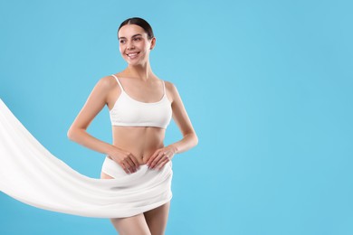 Photo of Diet and weight loss concept. Beautiful young woman with slim body on light blue background. Space for text