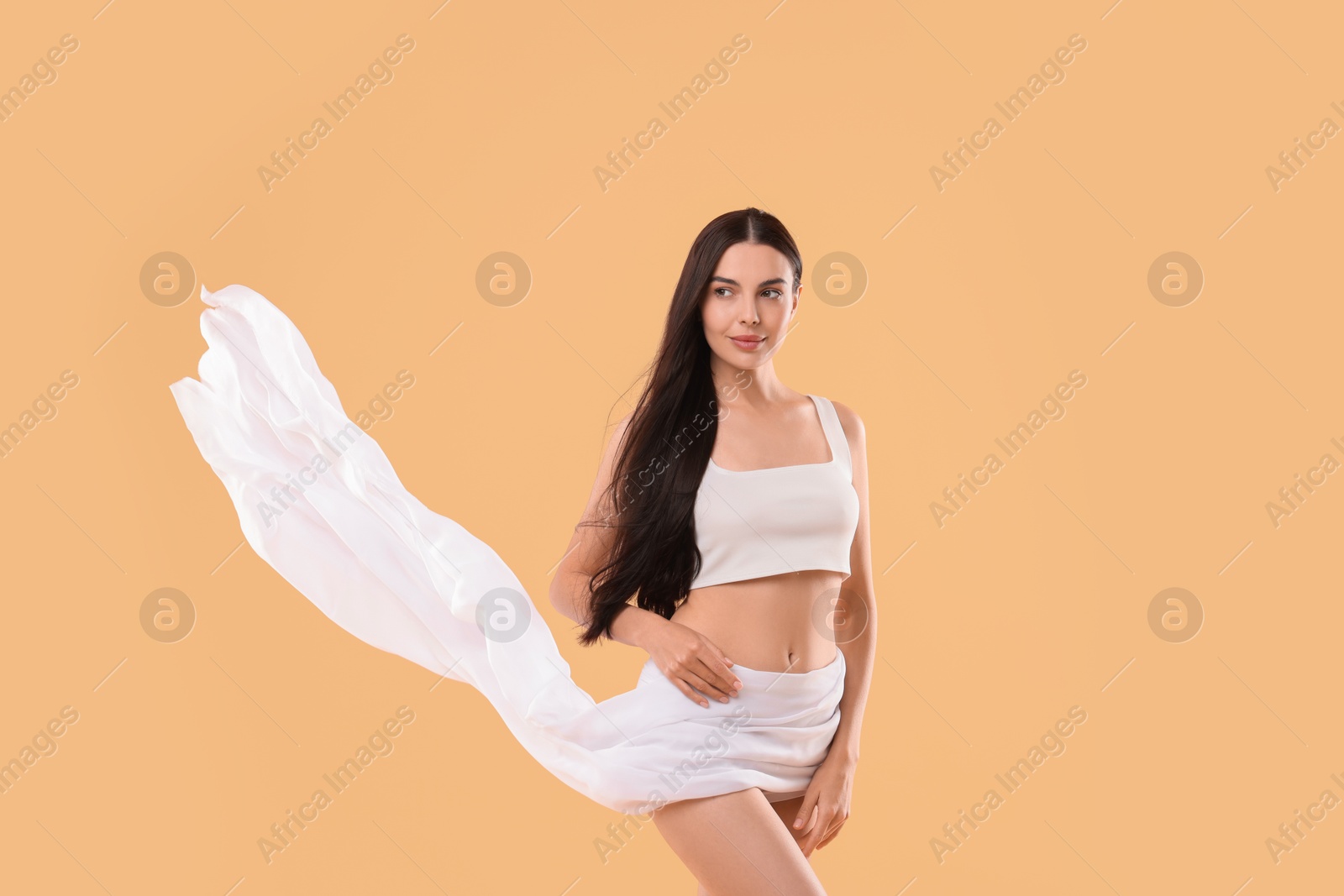 Photo of Diet and weight loss concept. Beautiful young woman with slim body on beige background