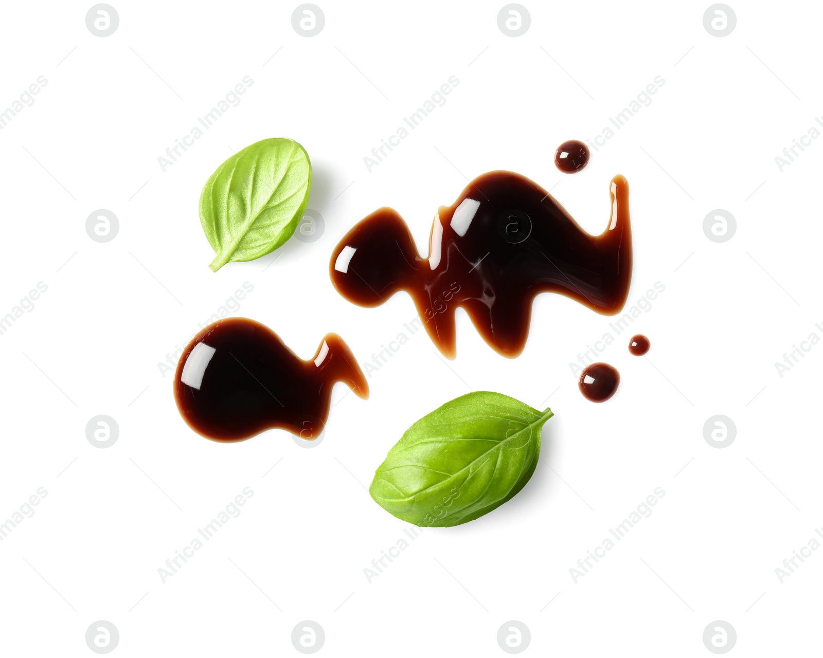 Photo of Delicious balsamic vinegar and basil leaves isolated on white, top view