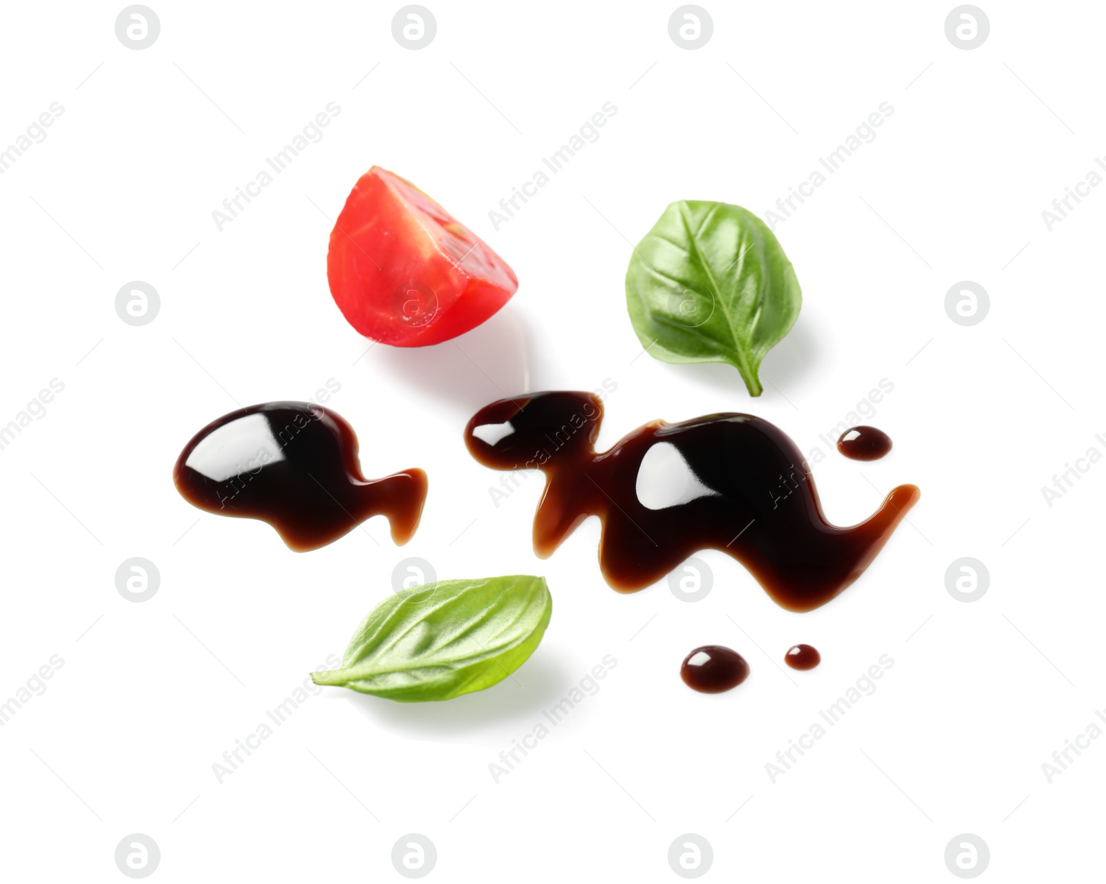 Photo of Delicious balsamic vinegar, cut tomato and basil isolated on white