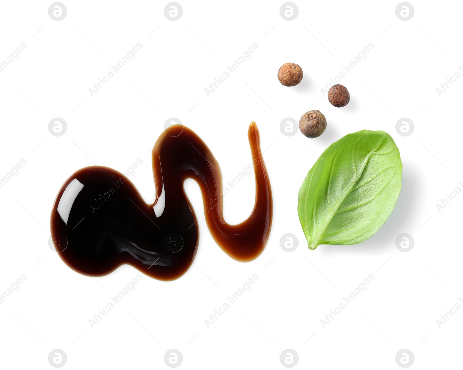 Photo of Delicious balsamic vinegar, basil and peppercorns isolated on white, top view