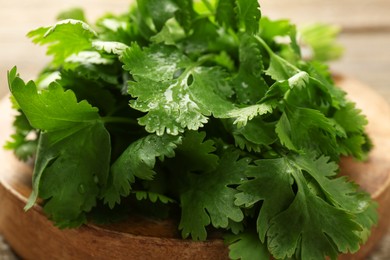 Bunch of fresh coriander on table, closeup