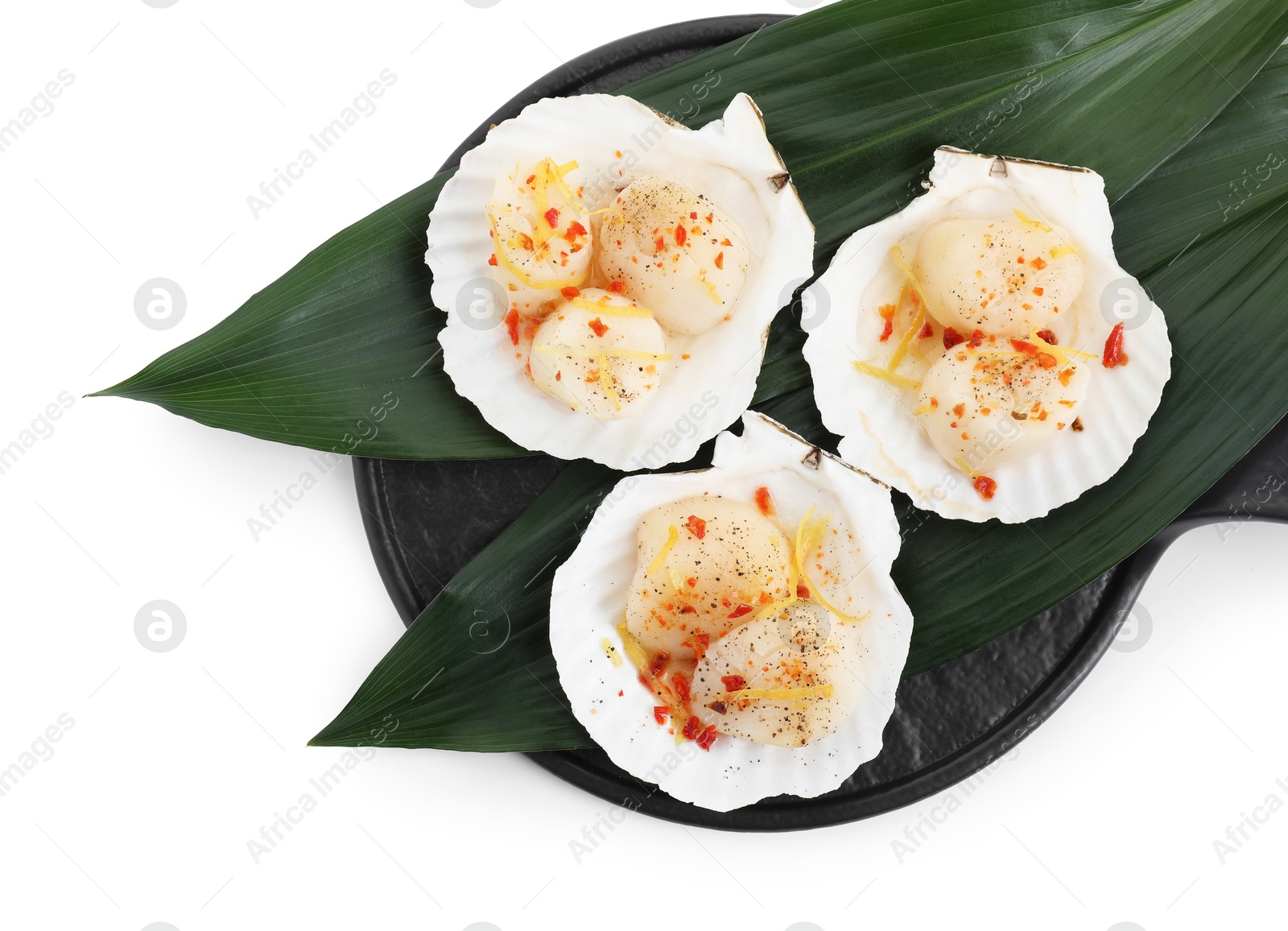 Photo of Raw scallops with spices, lemon zest and shells isolated on white, top view