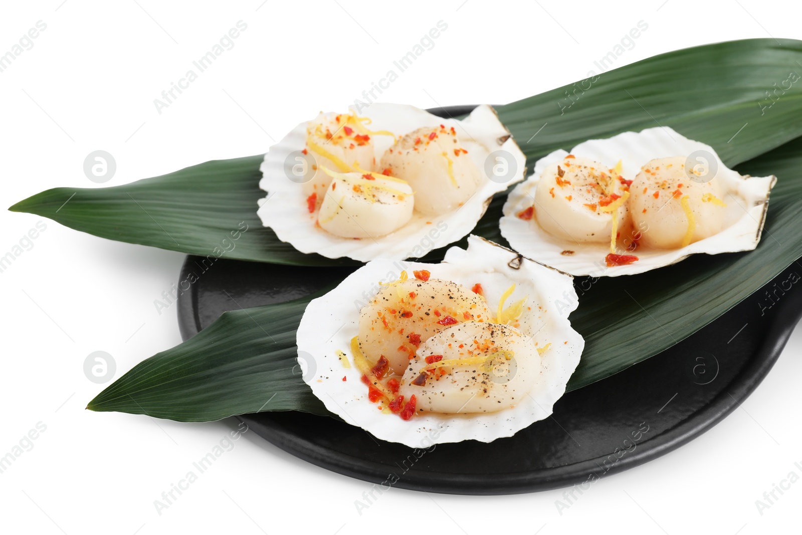 Photo of Raw scallops with spices, lemon zest and shells isolated on white