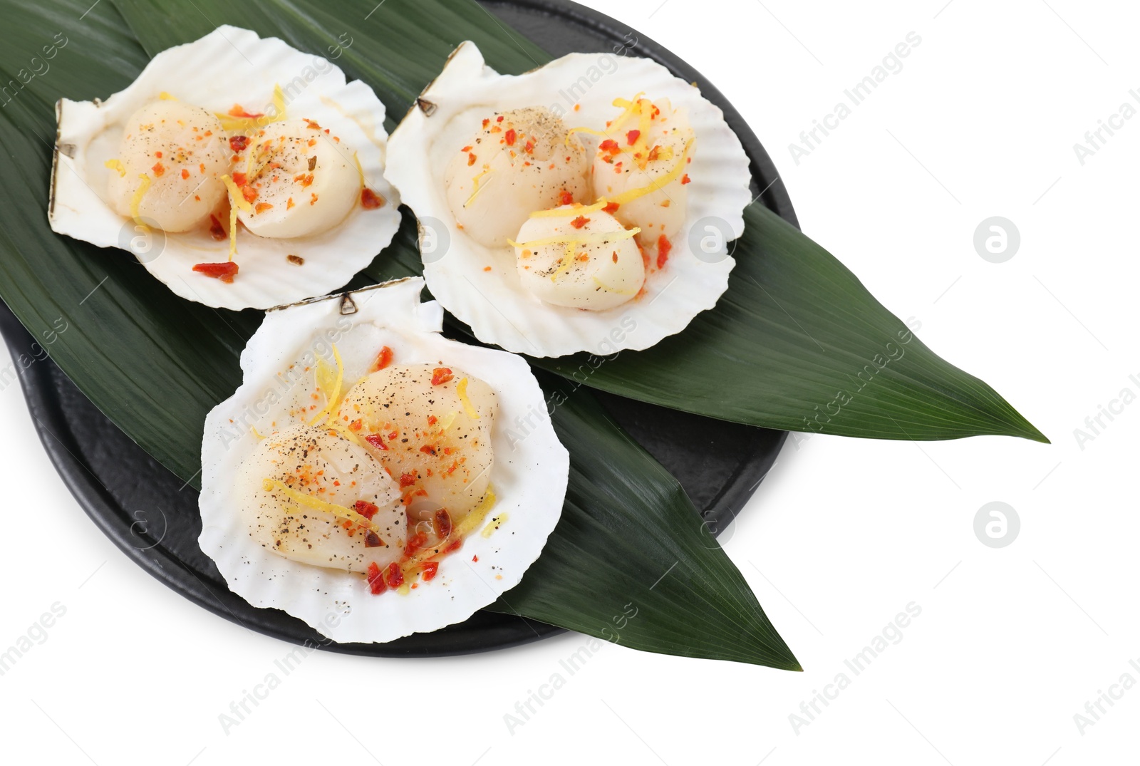 Photo of Raw scallops with spices, lemon zest and shells isolated on white, above view