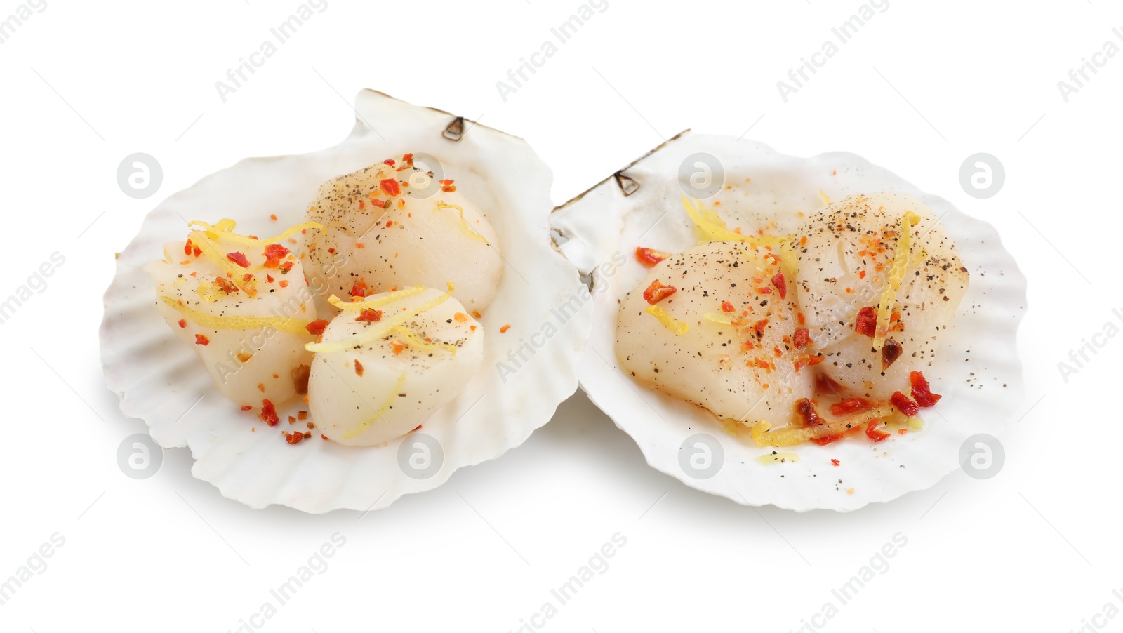 Photo of Raw scallops with lemon zest, spices and shell isolated on white