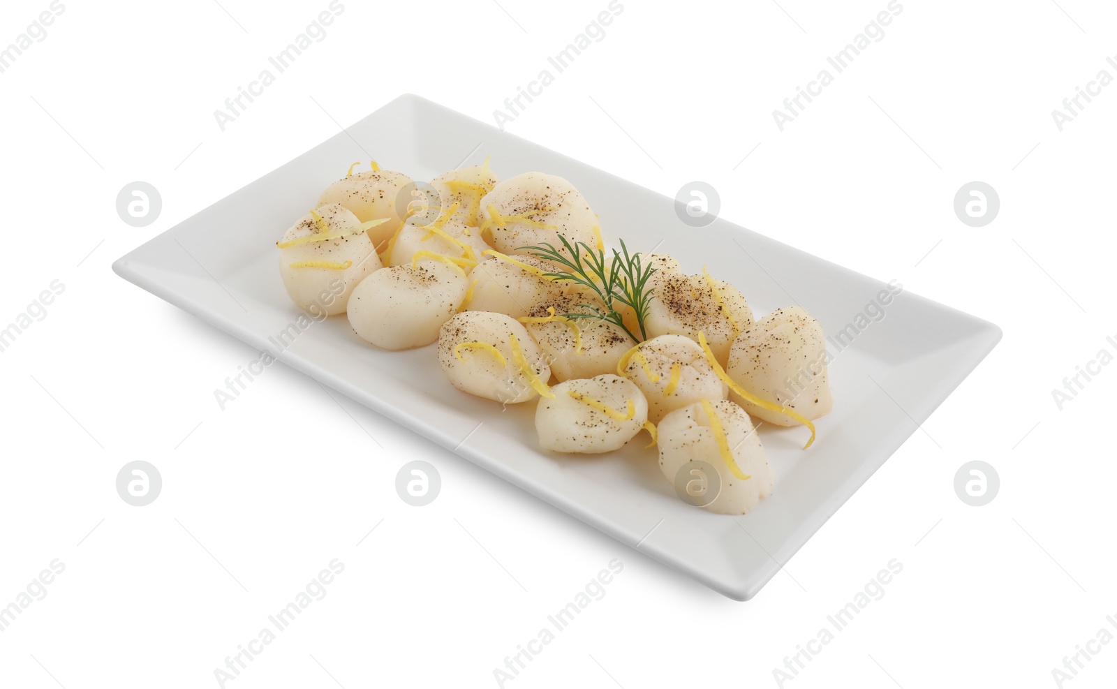 Photo of Raw scallops with milled pepper, dill and lemon zest isolated on white