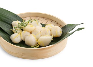 Raw scallops with thyme and lemon zest isolated on white