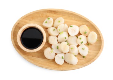 Raw scallops with green onion and soy sauce isolated on white, top view