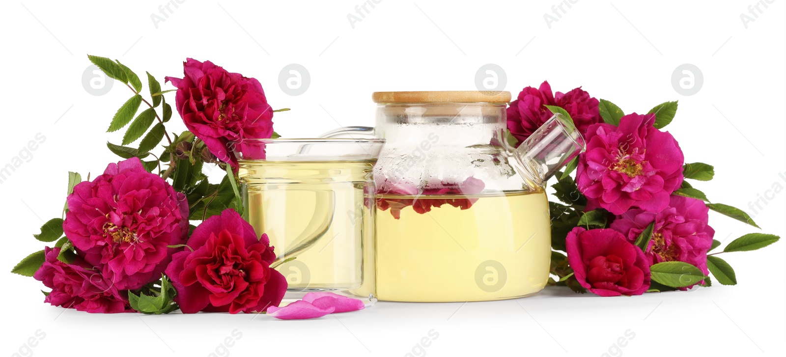 Photo of Aromatic herbal tea with rose flowers isolated on white