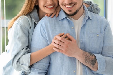 Photo of Happy couple holding hands at home, closeup