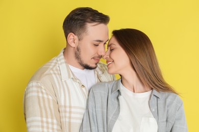 Photo of Happy couple on yellow background. Strong relationship