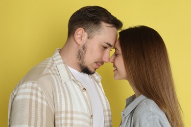 Photo of Cute couple on yellow background. Strong relationship