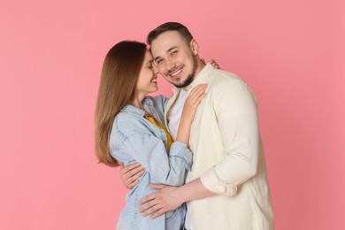 Photo of Happy couple hugging on pink background. Strong relationship