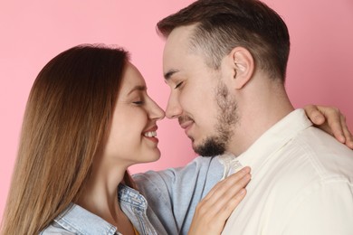 Photo of Happy couple on pink background. Strong relationship