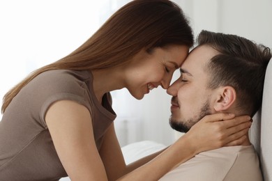 Smiling woman hugging her husband at home