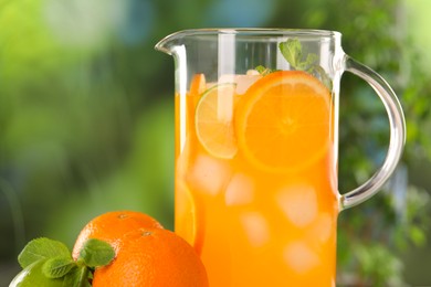 Freshly made lemonade in jug and citrus fruits outdoors