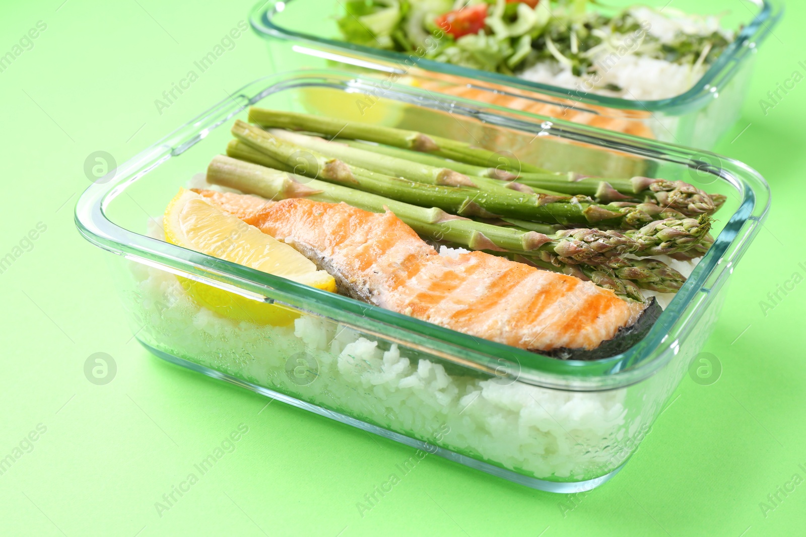 Photo of Healthy meal. Different products in glass containers on green background, closeup