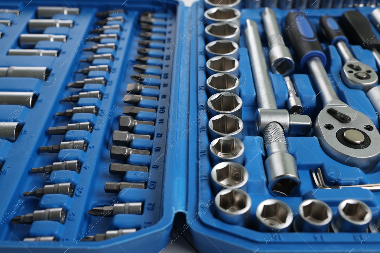 Photo of Auto mechanic's tools in plastic box on table, closeup