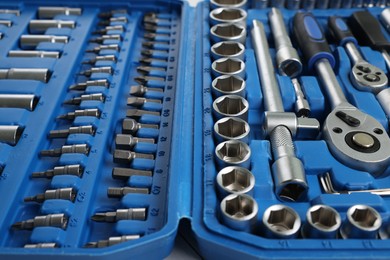 Auto mechanic's tools in plastic box on table, closeup