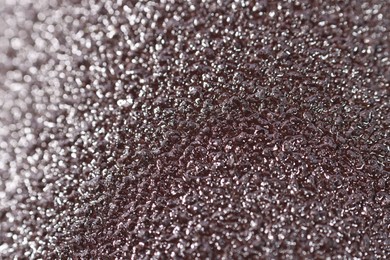 Photo of Texture of coarse sandpaper as background, closeup