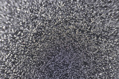 Photo of Texture of coarse sandpaper as background, closeup