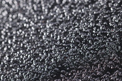 Photo of Texture of coarse sandpaper as background, closeup